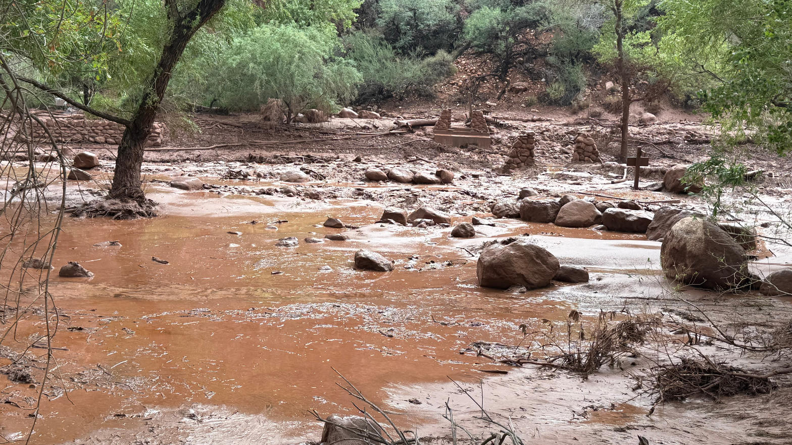 Muddy floodwater and debris in Bright Angel Canyon after the flash flood